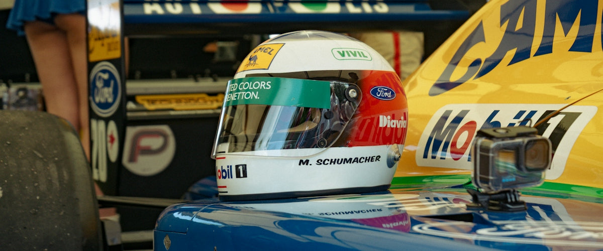Formula one helmet with colorful design on race car
